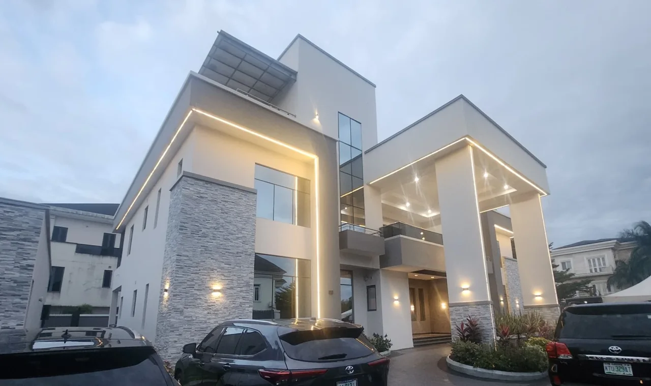 Banana Island residence at dusk, with a tall entrance portico and warm facade lighting